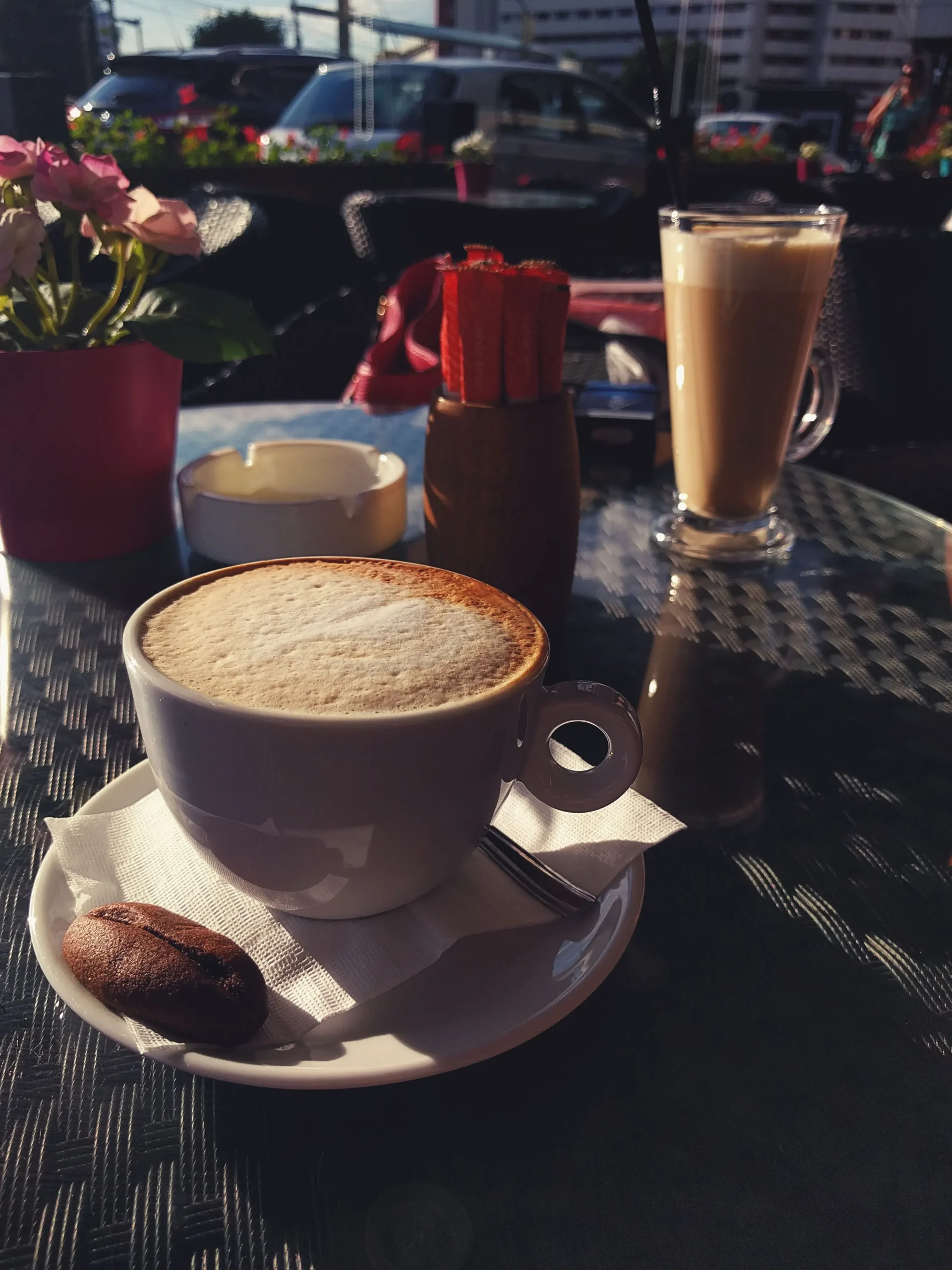 View from a café table in Durrës overlooking part of the city, with an espresso cup in the foreground.